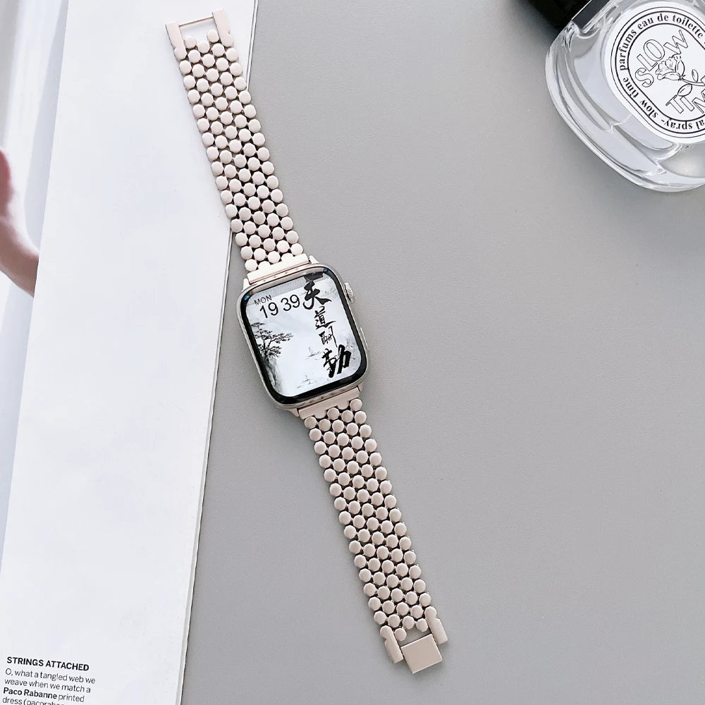 Elegant stainless steel Apple Watch band for women with a polished slim-link design, perfect for formal and casual wear.